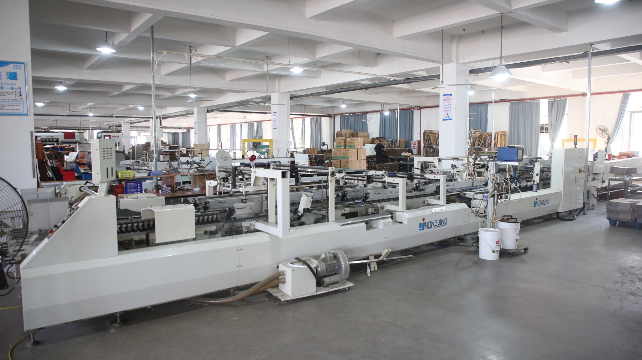 Paper-packaging production equipment across the workshop floor